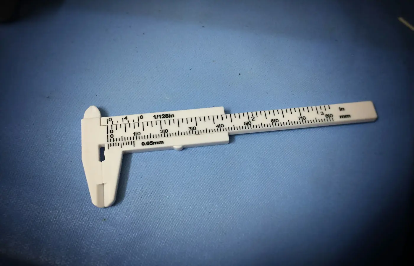 A micrometer measuring the caliper of a sheet of paper