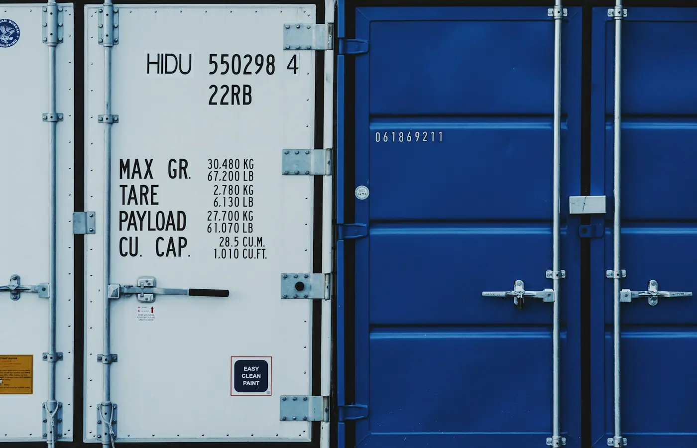 a couple of blue and white shipping containers